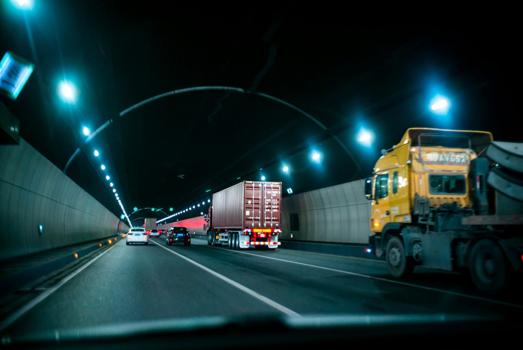 Freight vehicles on a road at dusk